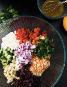 Greek Orzo salad ingredients in bowl