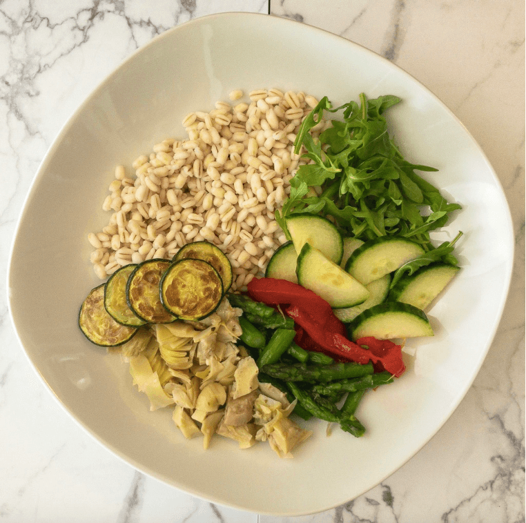 Adding vegetables to grain bowl