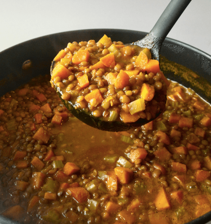 Big ladle of lentil vegetable soup