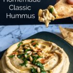 Homemade classic hummus with dip on a chip