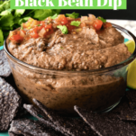 Black Bean Dip with tomatoes sprinkled on top served with tortilla chips