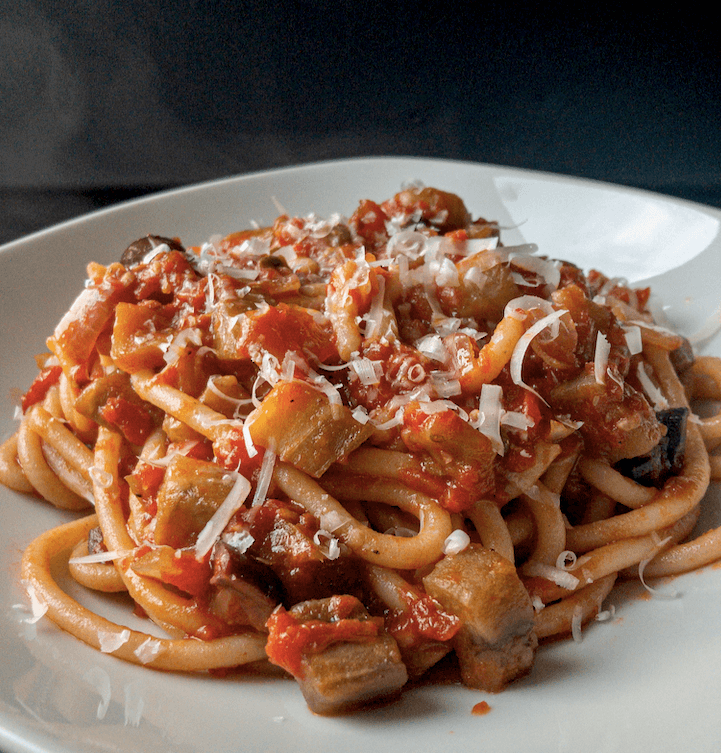 Pasta plated with parmesan cheese garnish