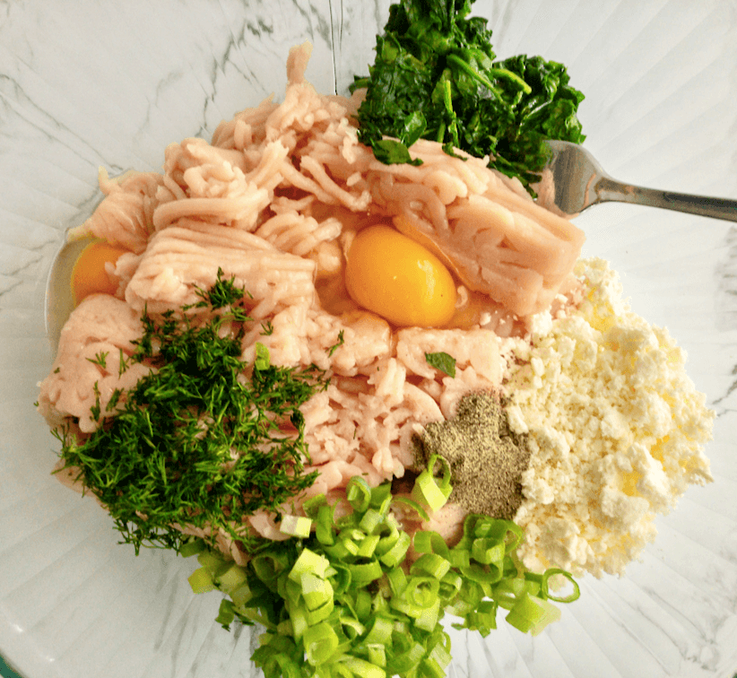 ingredients for chicken burgers in a mixing bowl