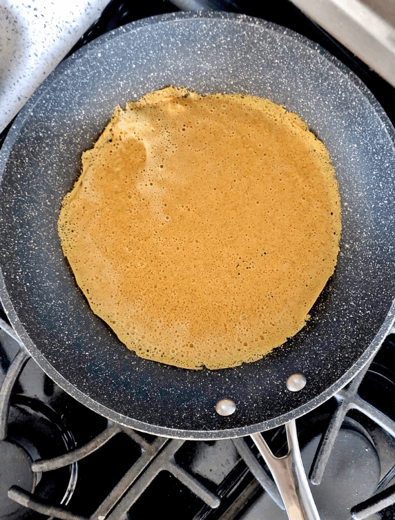 making crepes in a skillet pan