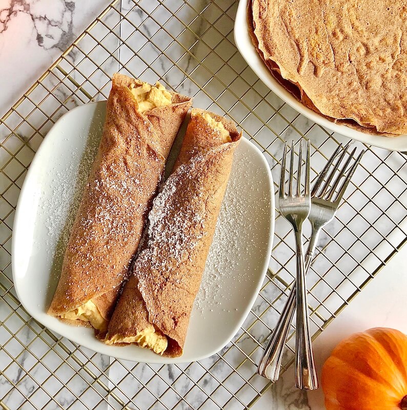 plated pumpkin crepes served with a pumpkin cheesecake filling