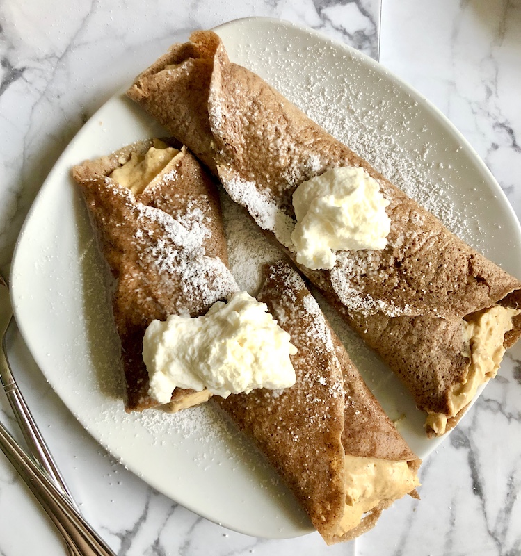pumpkin crepes with pumpkin cheesecake filling with whipped cream