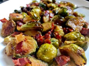 close up roasted brussels sprouts with pieces of bacon