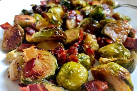 close up roasted brussels sprouts with pieces of bacon