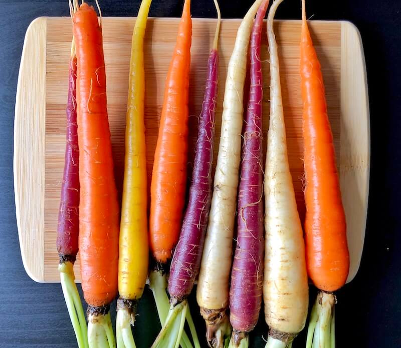 rainbow carrots on cutting board