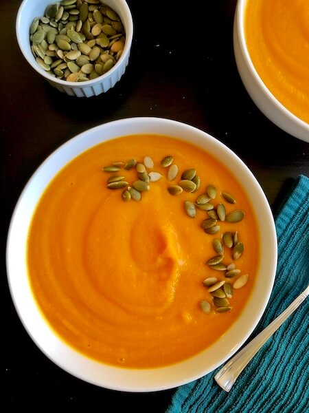 bowl of soup garnished with pumpkin seeds
