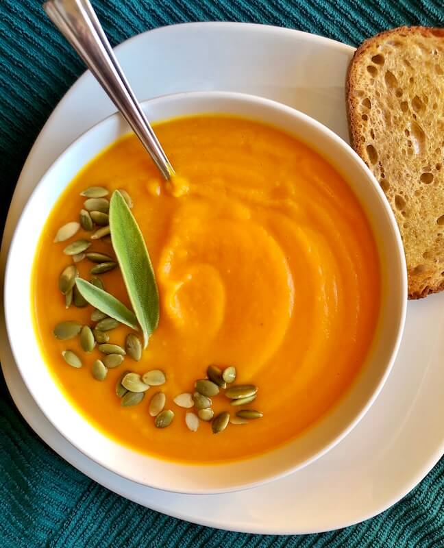 bowl of butternut squash soup with bread