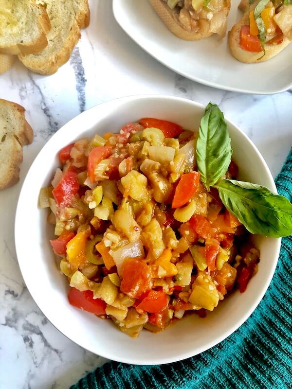 bowl of eggplant salad with toasted baguette