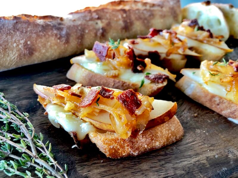 crostini with brie cheese, onions, pear and bacon