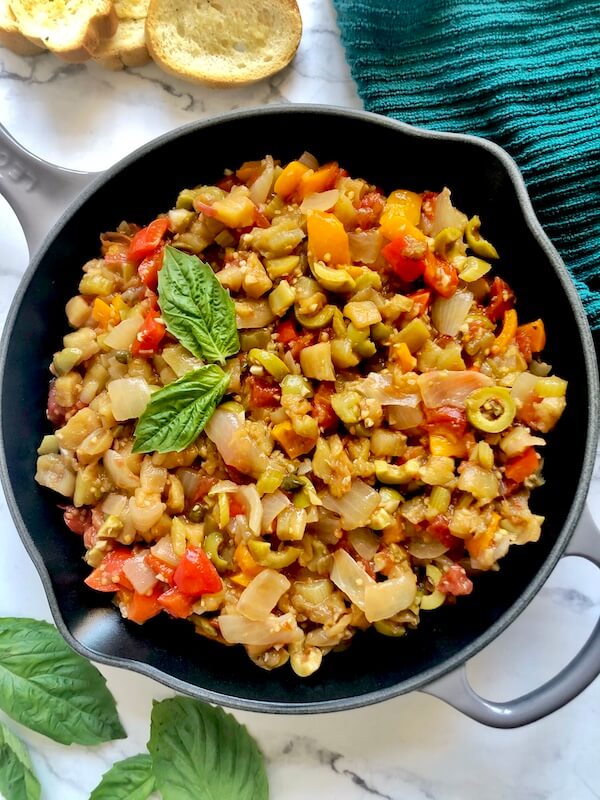 pan of eggplant, peppers, tomatoes, onions, olives, and capers