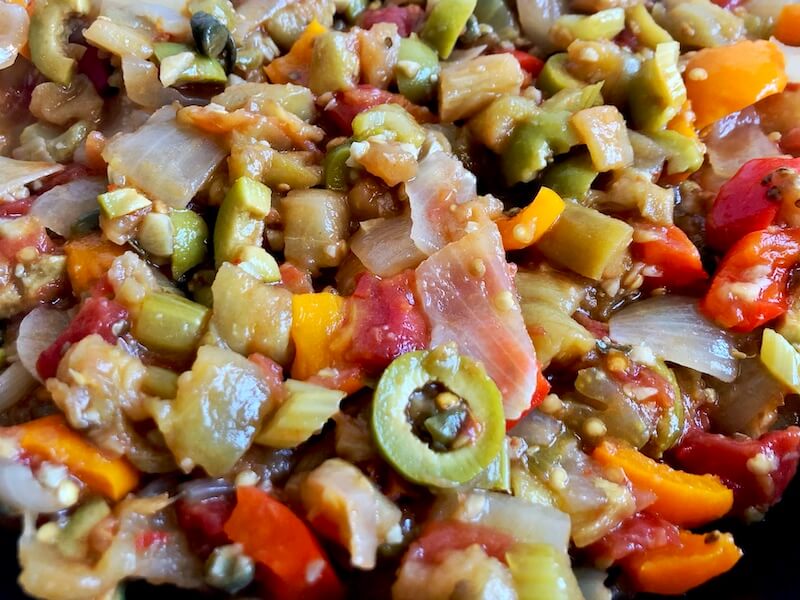 up close vegetables mixed with olives, garlic and capers