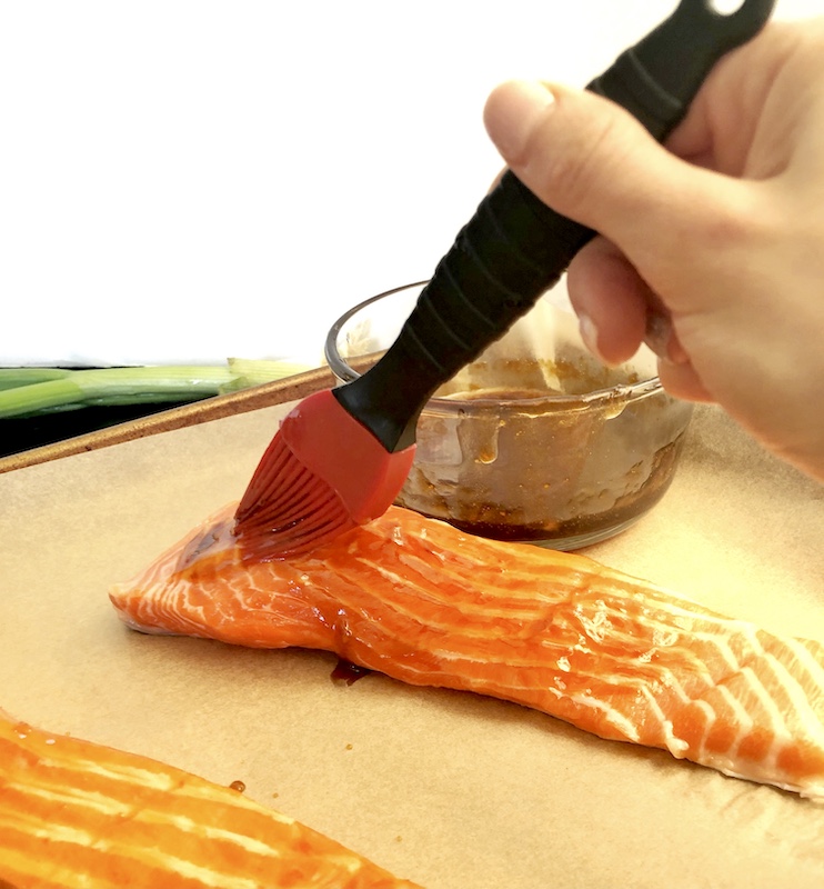 brushing sesame ginger glaze on salmon