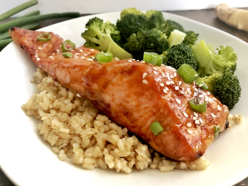salmon served over rice with broccoli
