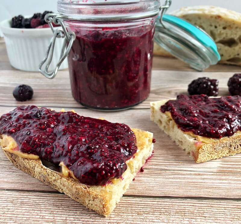 side view of toast with peanut butter and berry jelly