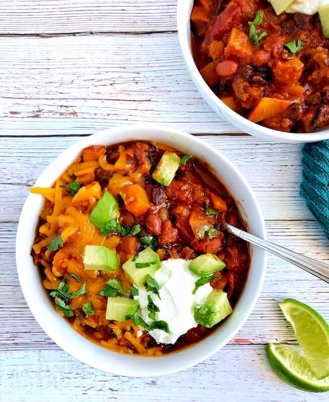 two bowls of chili with beans and winter squash
