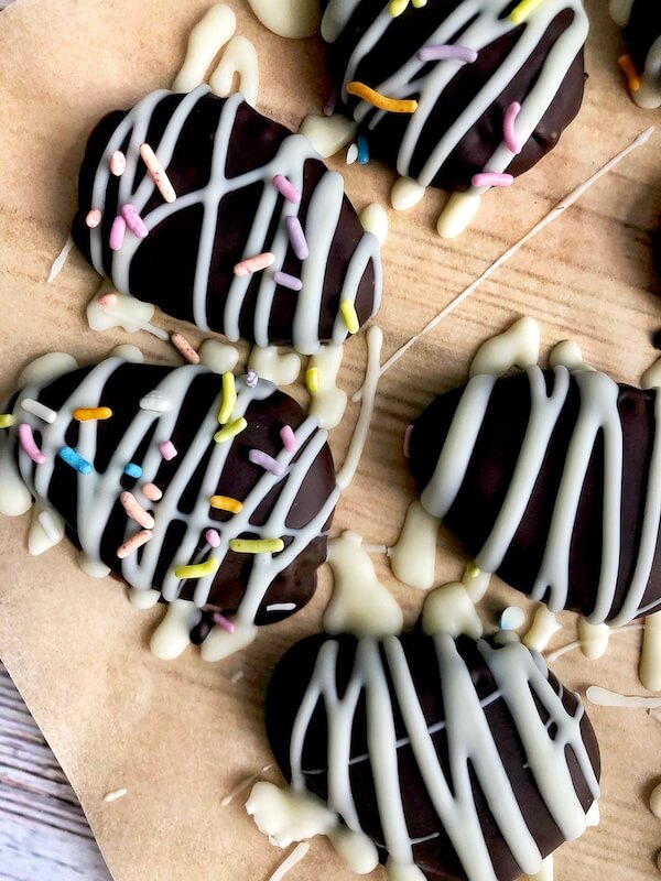 drizzling white chocolate on homemade chocolates