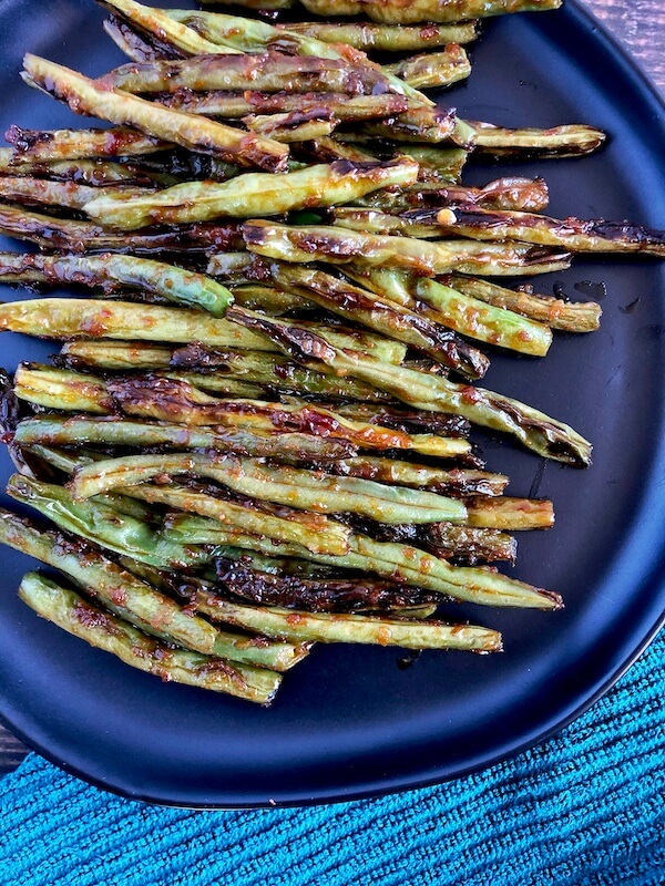 plate of green beans with asian sauce