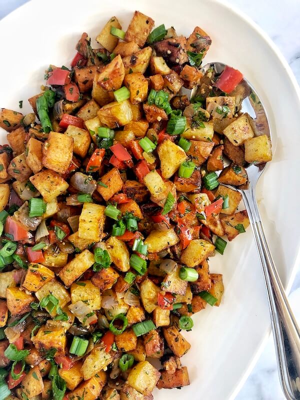 roasted sweet potatoes and white potatoes with herbs, onions and peppers