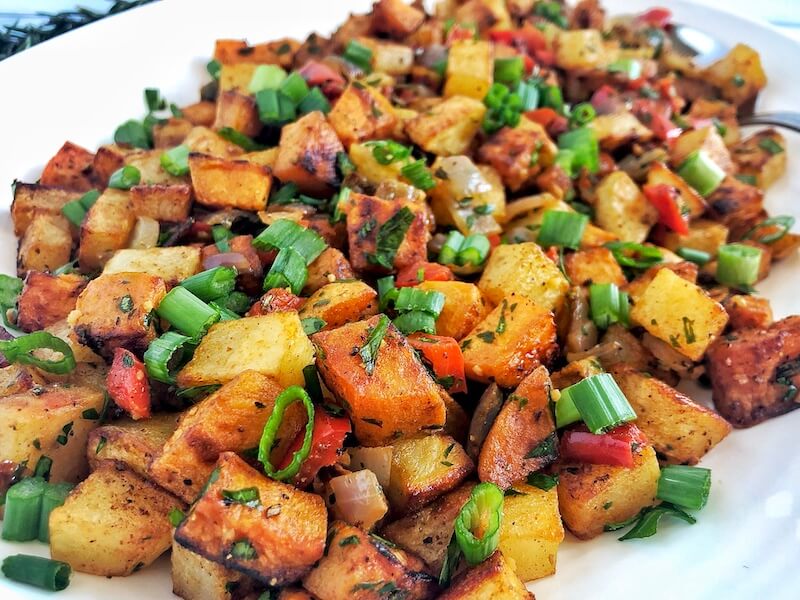 up close vegetarian potato hash with peppers and onions