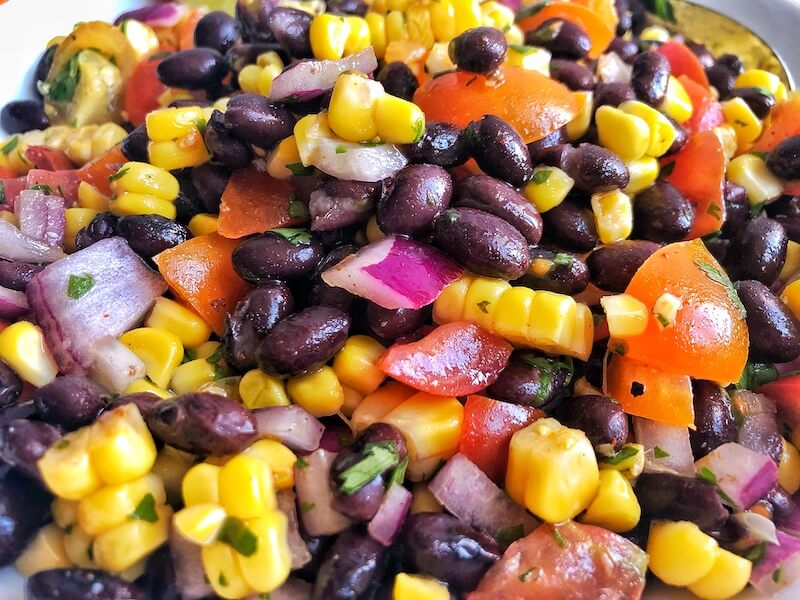 up close Mexican salad with beans, corn and tomatoes