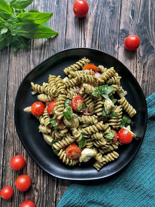 plate of pesto pasta with tomatoes and mozzarella