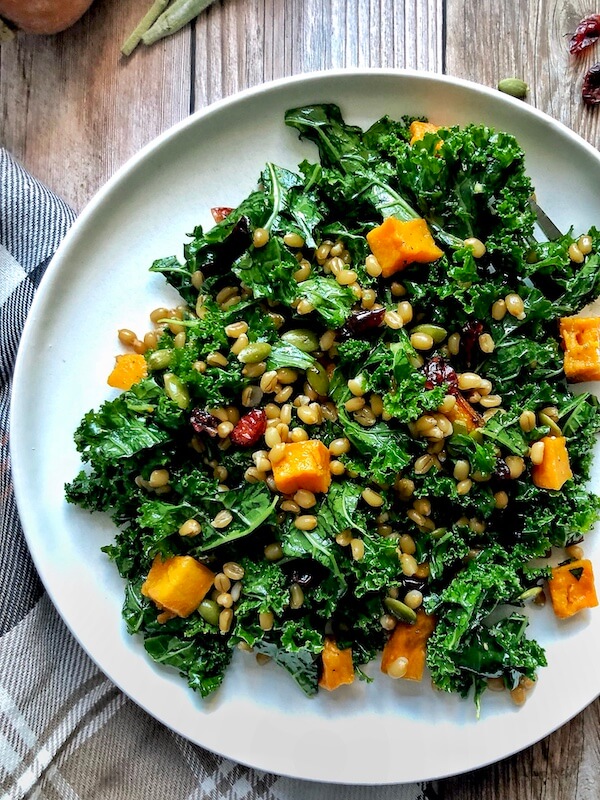 plate of kale salad with roasted butternut squash