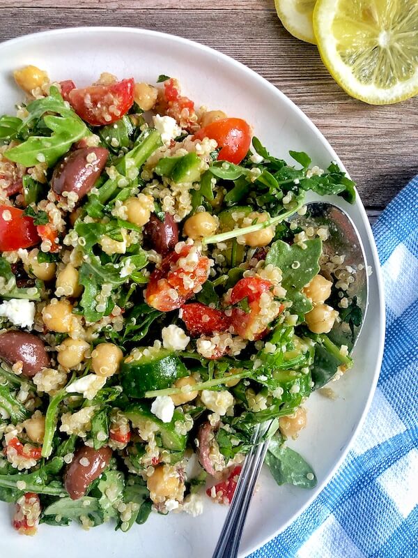 Arugula salad with quinoa, chickpeas, roasted red peppers, cucumber